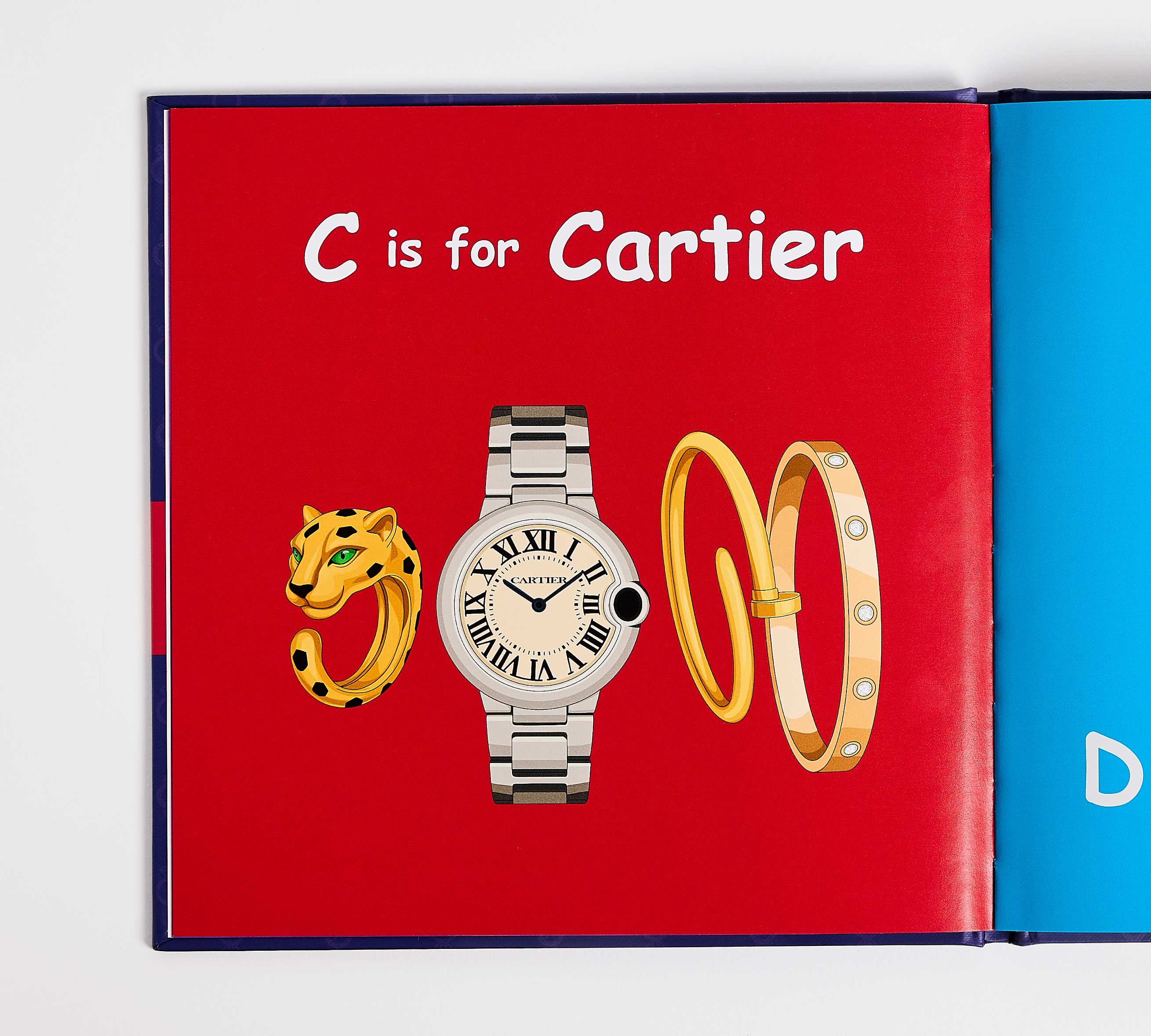 Book open to a page with 'C is for Cartier' text and Cartier logo illustrations.