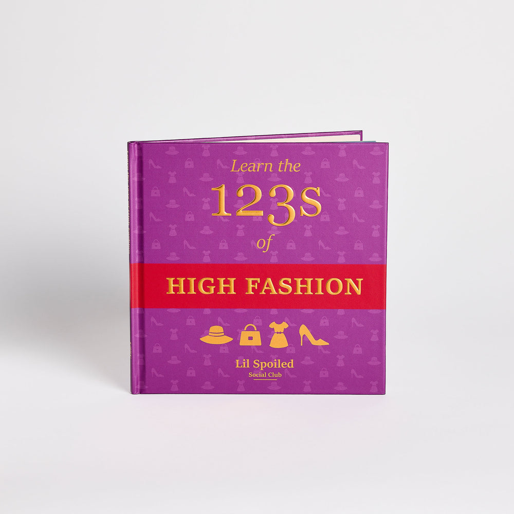 Purple book titled 'Learn the 123s of High Fashion' with a red section on a white background